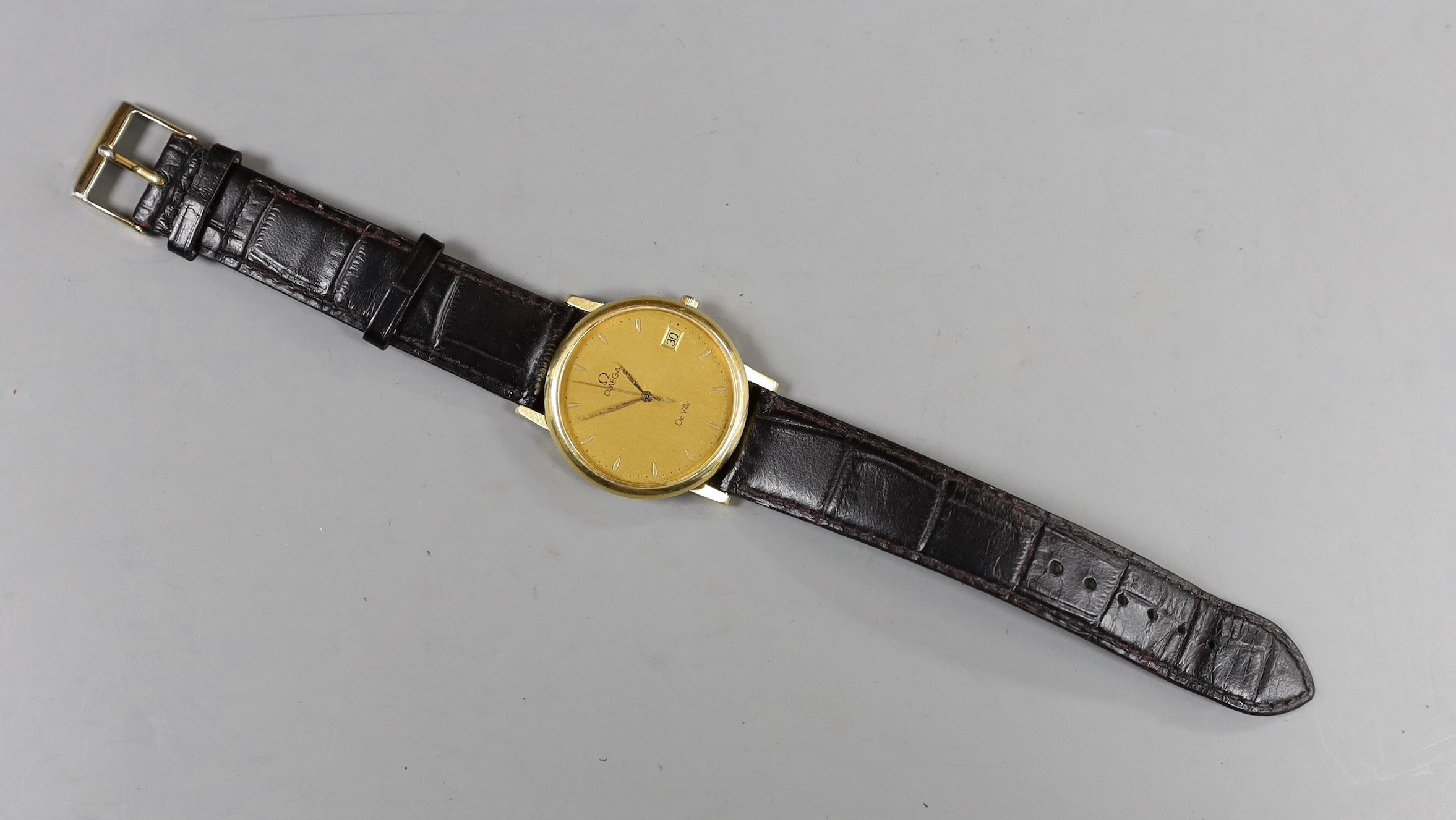 A gentleman's 18ct gold Omega De Ville quartz wrist watch, on associated leather strap, with Omega box.